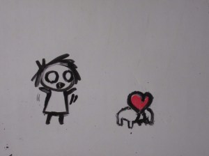 Still from "Whatcha Doin?" Emily talks to her heart